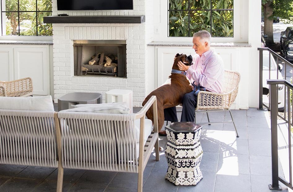 man and his best friend by an outdoor fireplace