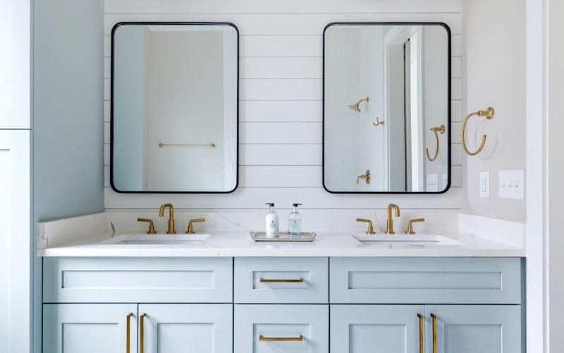 a bathroom with blue cabinets