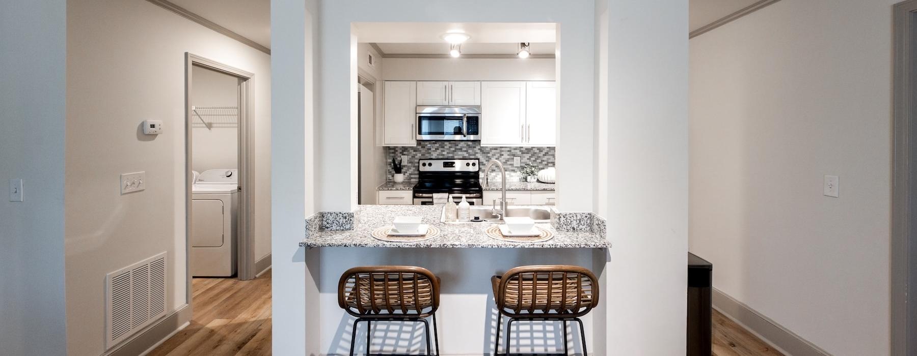 a kitchen with a table and chairs