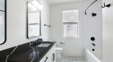 a bathroom with a tub, sink and toilet