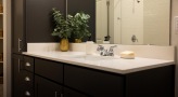 a bathroom with a large mirror and a sink