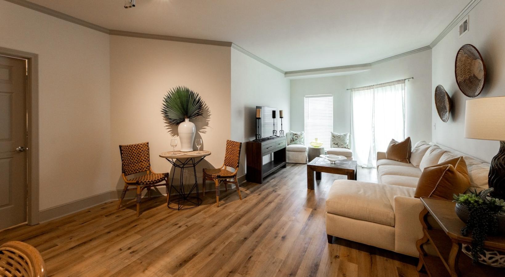 a living room with a couch, tables and chairs