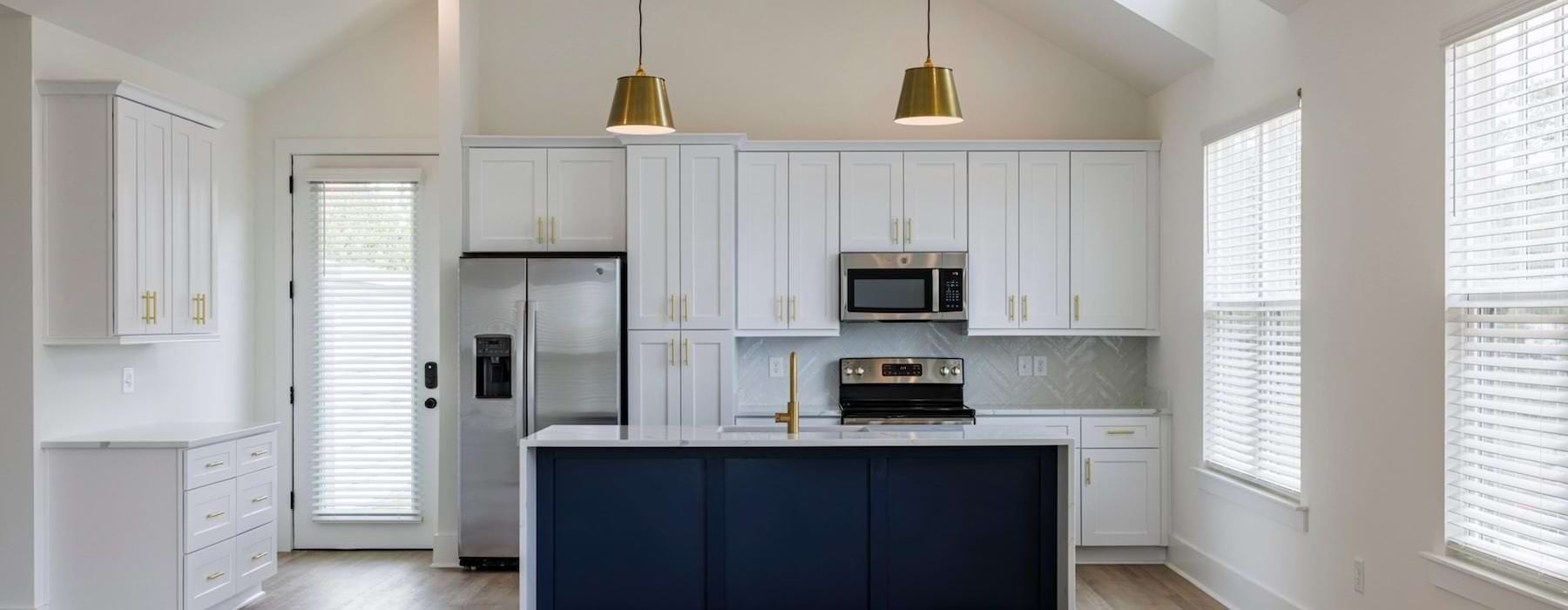 a kitchen with white cabinets