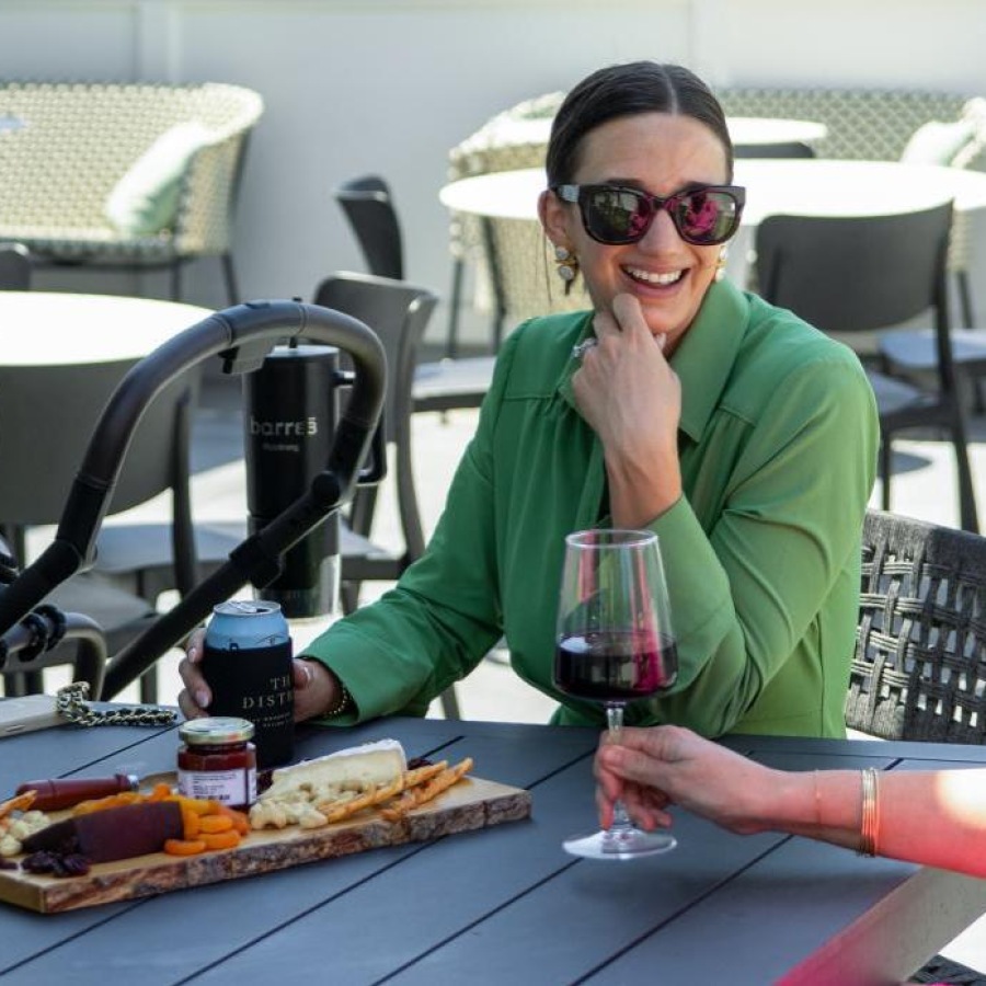 a group of women sitting at a table with food and drinks