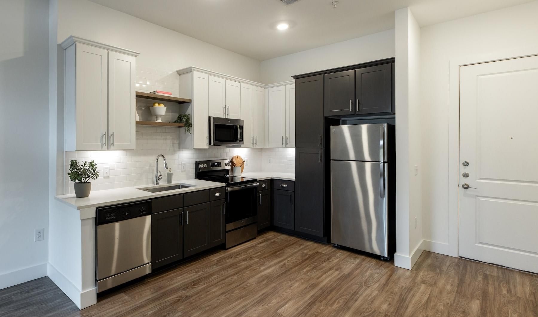 a kitchen with white and black cabinets
