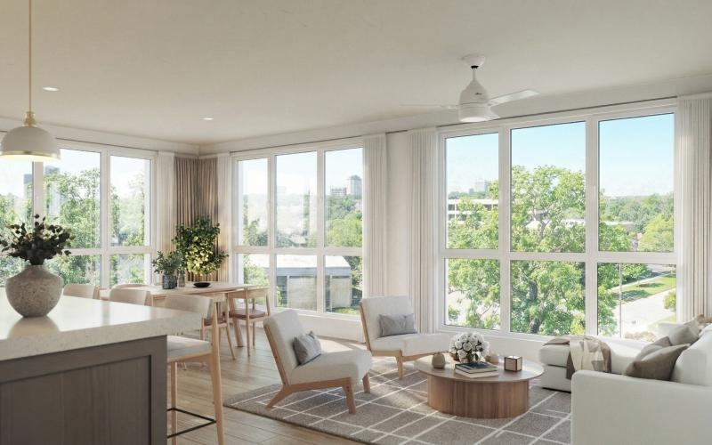 a living room with a couch, tables and chairs