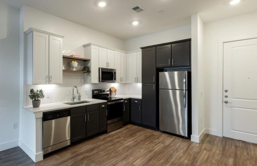 a kitchen with white and black cabinets