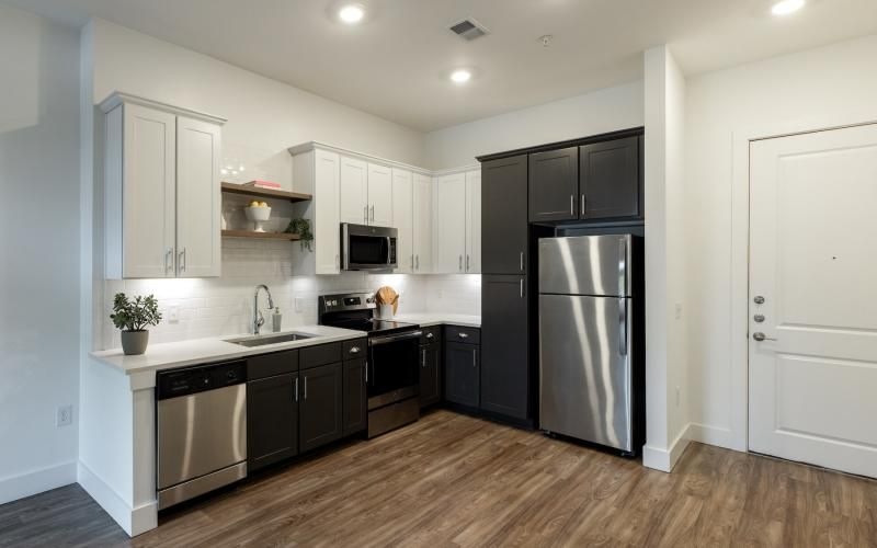 a kitchen with white and black cabinets