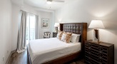 a bedroom with a bed and lamps