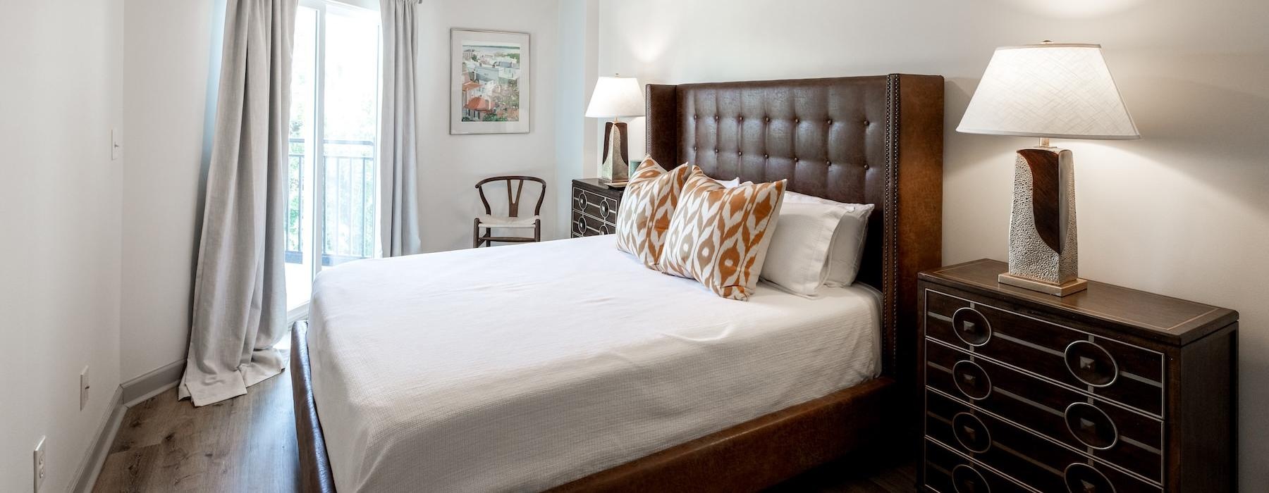 a bedroom with a bed and lamps