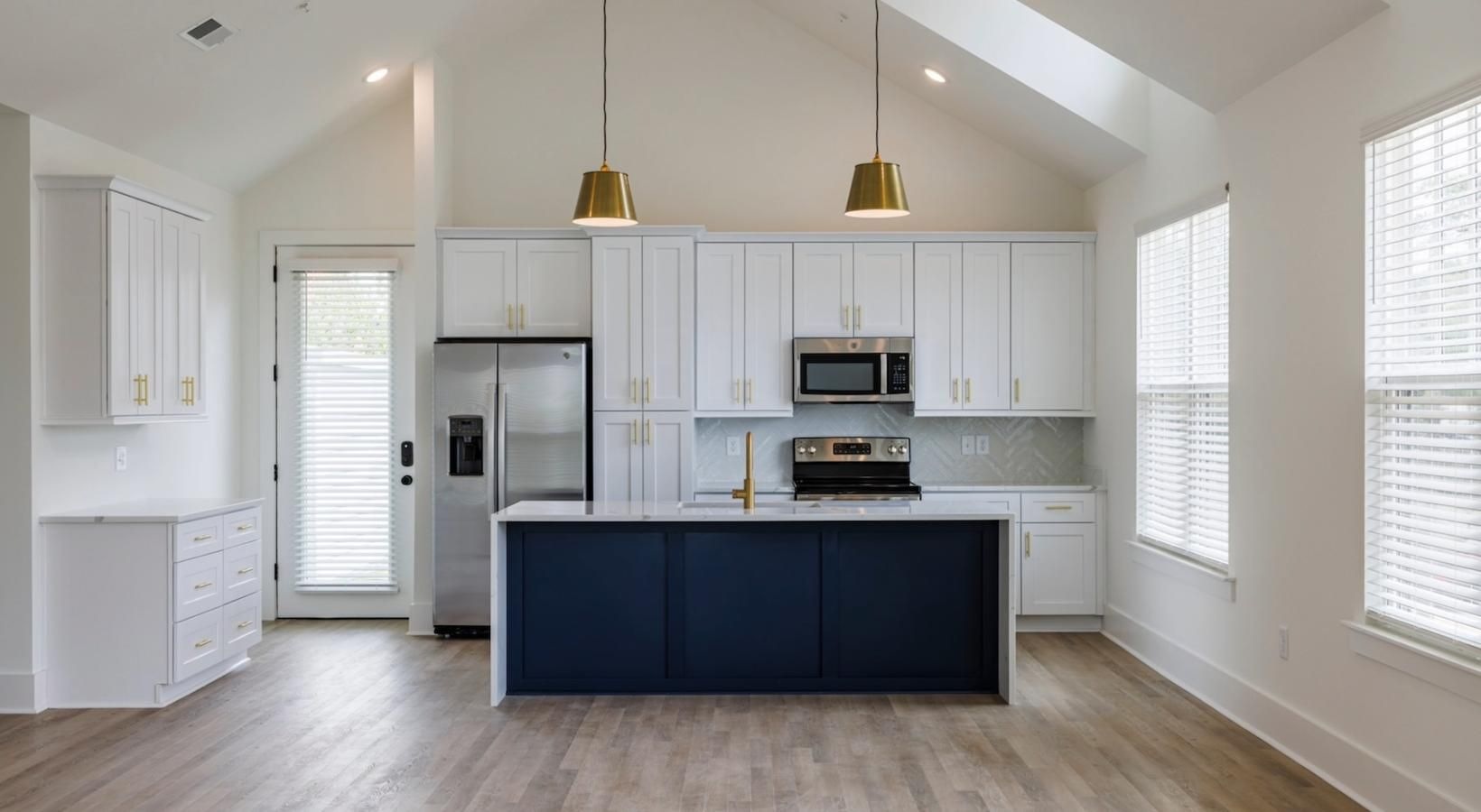 a kitchen with white cabinets